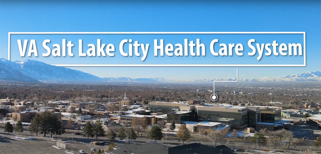 Aerial view of the George E. Wahlen VA Medical Center surrounded by the Wasatch mountains. Text reads: VA Salt Lake City Health Care System.