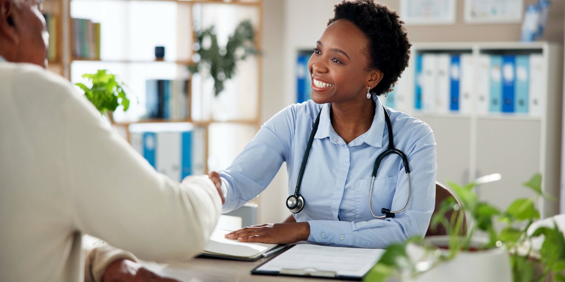 Doctor and patient shaking hands in a clinic.