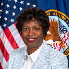 Ann Blunt in front of US flag 