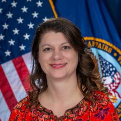 Regina Latimer in front of US flag
