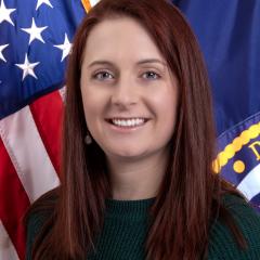 Meriel standing in front of USA flag