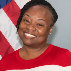 Woman standing in front of U.S. flag