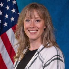 Provider Nicole Crowder posing in front of an American flag.