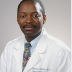 Portrait of a doctor in white lab coat and tie, posing for the camera.