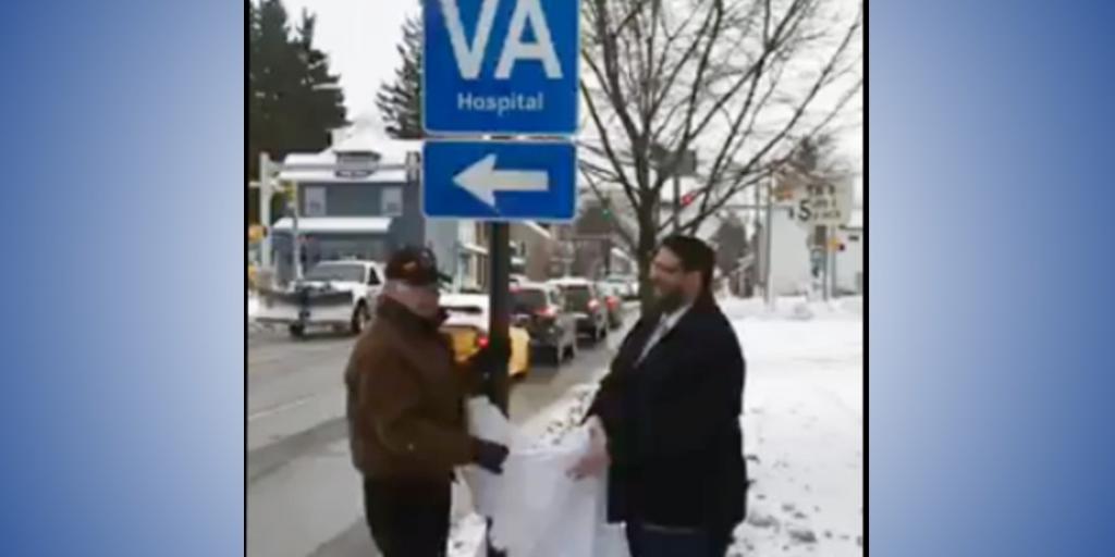 Photo of the Mayor of Hollidaysburg, Joe Dodson and VAMC Associate Director unveiling VA street sign.