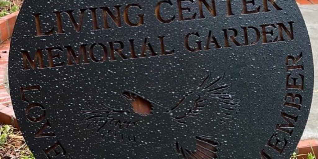 Charles George VA Medical Center Community Living Center has placed a new sundial shaped sign in its Memorial Garden. Inscribed on the sign are the words “Loved, Served, Remember”.
