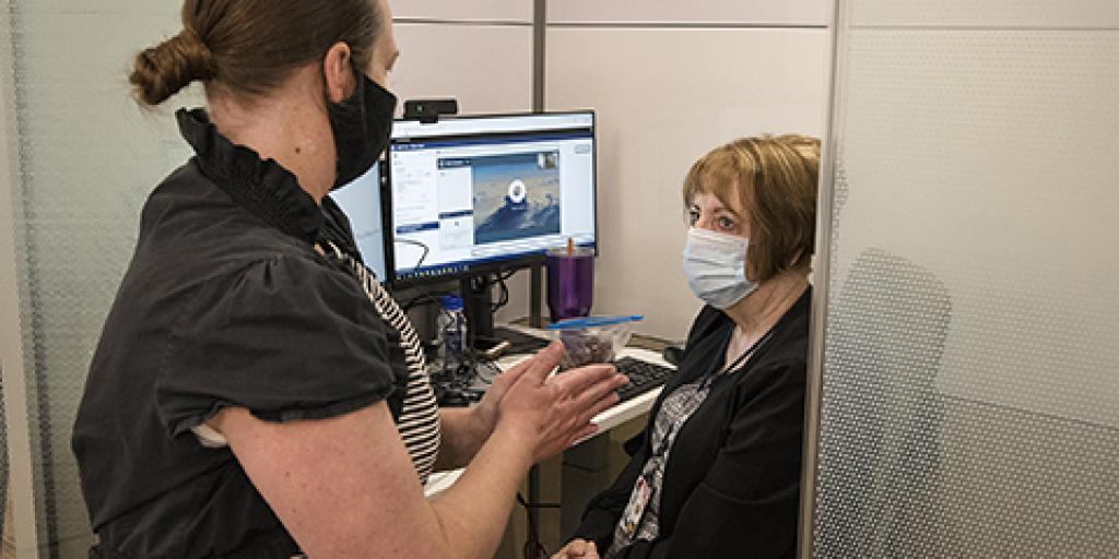 A VA Salt Lake City Health Care System TeleMental Health Program Coordinator instructs a provider on how to connect with Veterans using a video conferencing program.