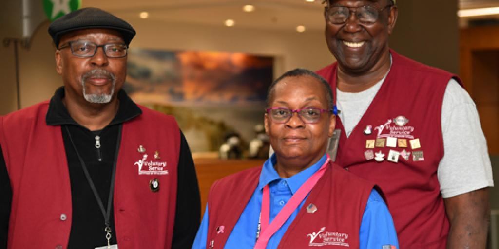Volunteers at Ralph H. Johnson VA Medical Center wear red vests to signify themselves as NaVAgators who help Veterans find their way to appointments throughout the hospital. (Photo by James Arrowood)
