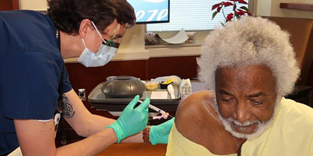 illiam Swinton, a U.S. Navy Veteran and Community Living Center resident, was the first Veteran to receive the Moderna COVID-19 vaccine at the Ralph H. Johnson VAMC on Dec. 22, 2020. Photo by James Arrowood.