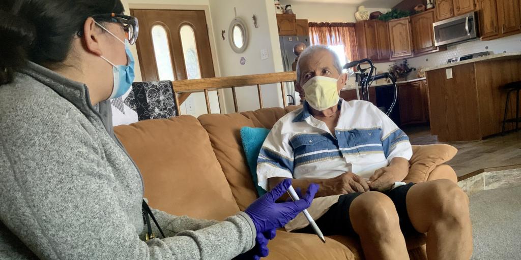 Dr. Karen Shea sits with Navy Veteran Francisco Montez at home in Pueblo County