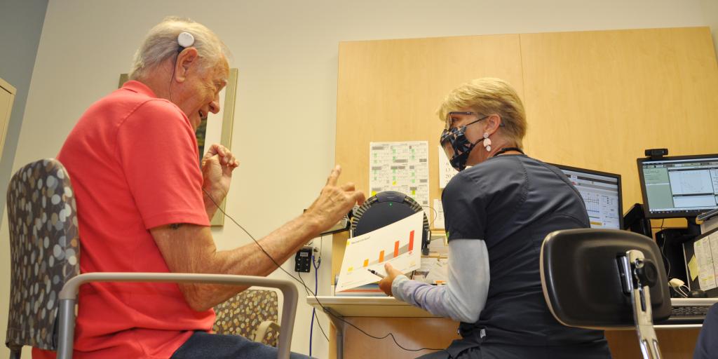 Dr. Randall works with Mr. Sheasby during a follow-up tuning appointment.