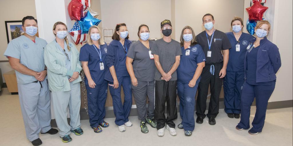 VA staff pose for a photo with a Veteran