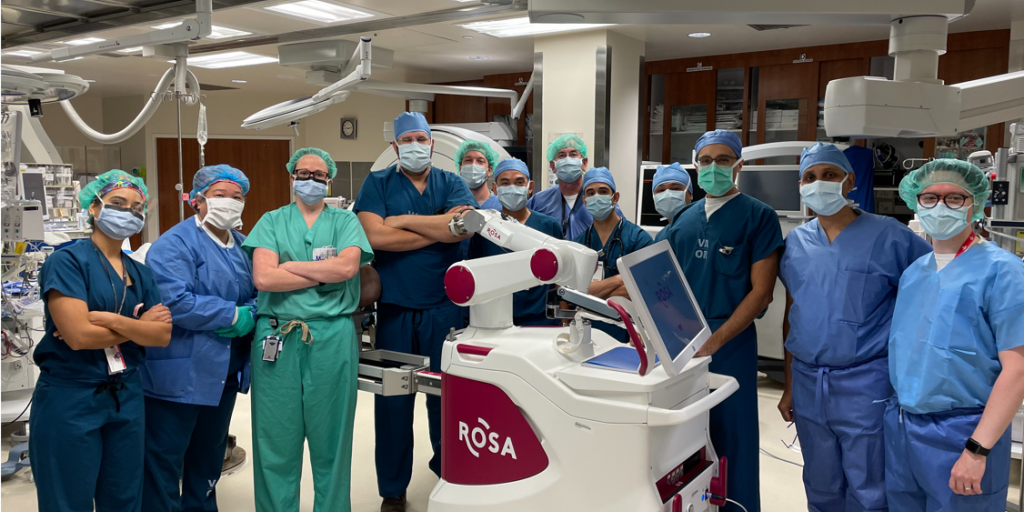 Surgeons pose with Robotized Surgical Assistant.