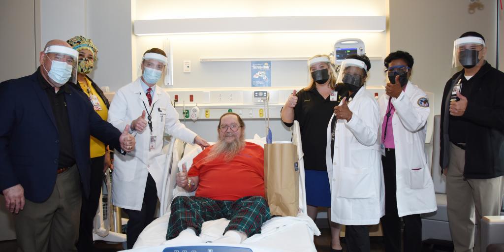 Image of Army Veteran Ray A. Primeaux visiting with hospital leadership.