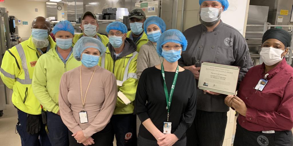 Food Service workers pose with certificate