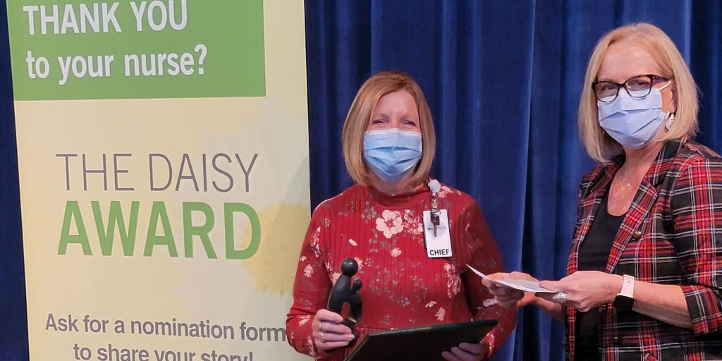 Carole Borland, Chief Nurse Inpatient Services (Left) is presented with a certificate and statue by Teresa Edgren, Associate Director for Patient Care Services (right) at the Madison VA Hospital. Borland was recently honored with the hospital’s first DAISY Award® For Extraordinary Nurses.