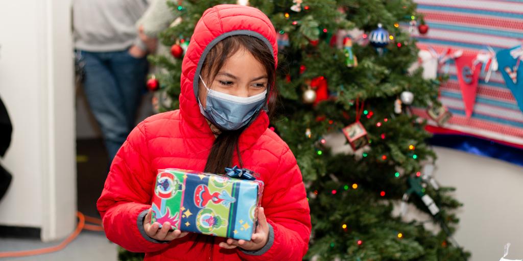 Student from Veteran Memorial Elementary school smiles after receiving gifts from VASNHCS staff.