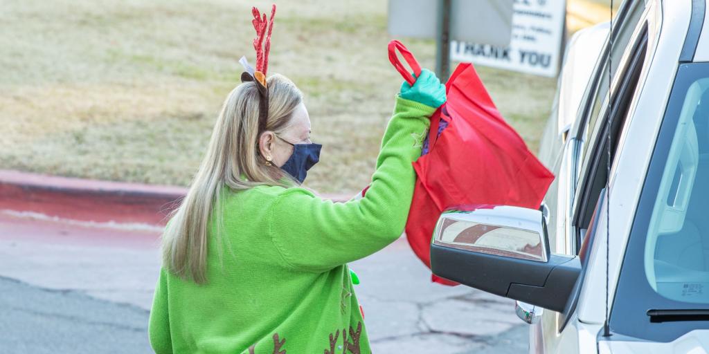 Woman gives a Veteran a gift bag.