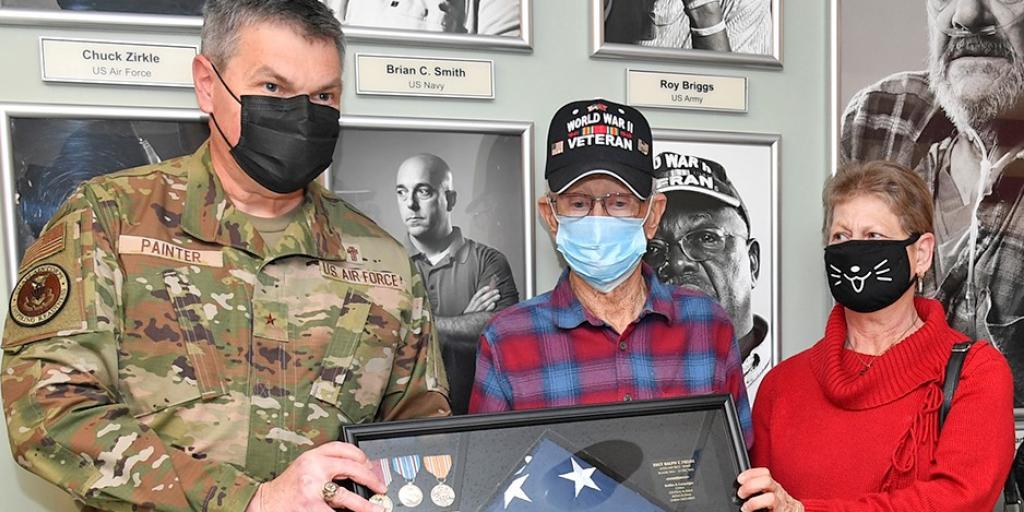 U.S. Air Force Reserve Brigadier General John Painter, who is also a Chaplain at the Charleston VA, presents Ralph Fields with his shadow box for his 97th birthday.