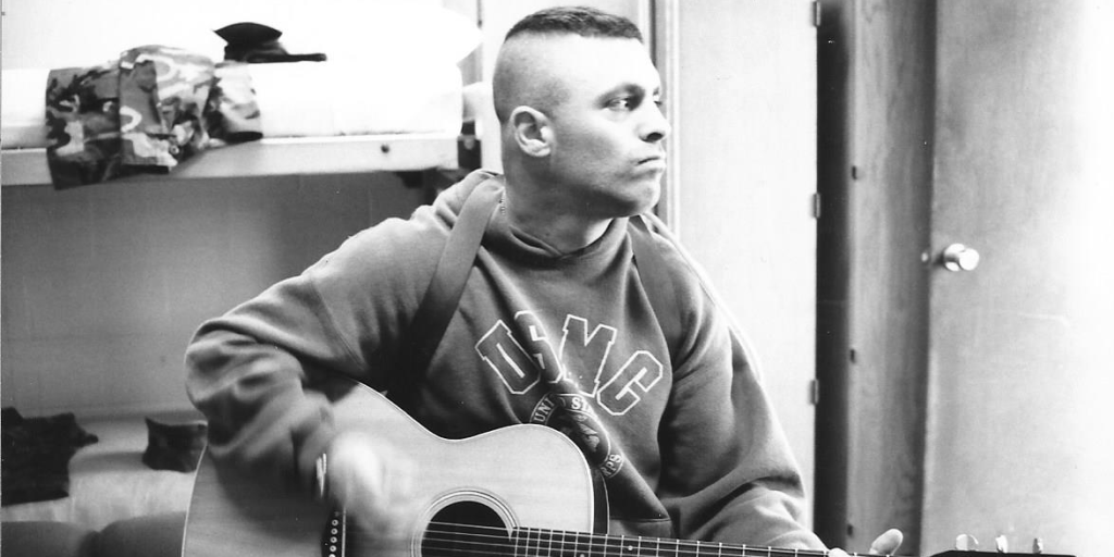 Marine Veteran Scotti Fraser playing guitar.