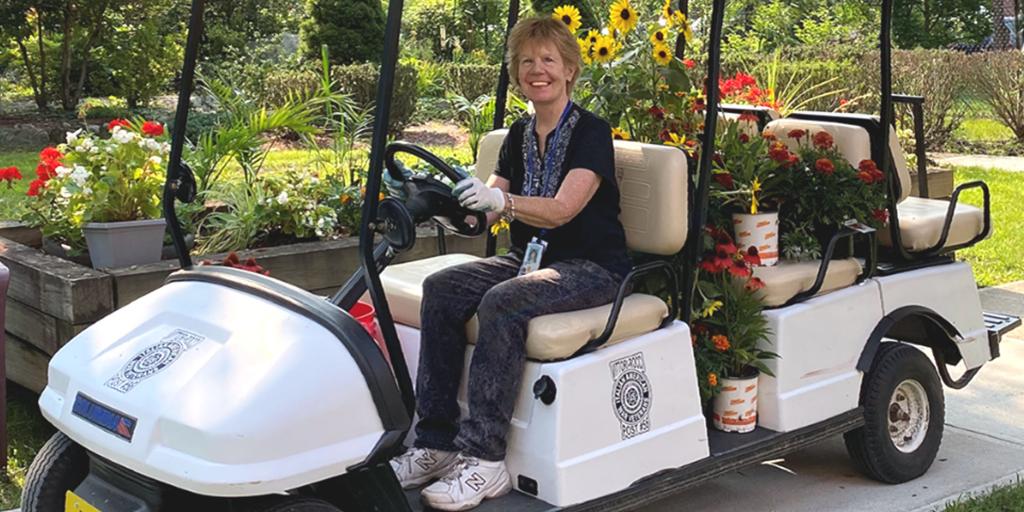 A woman driving a golf cart