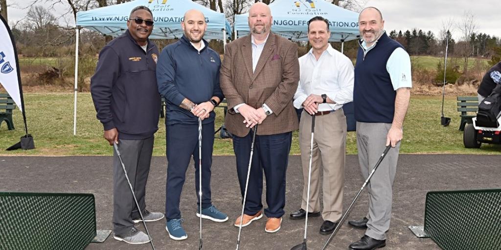 Dignitaries pose for photo following tee shot