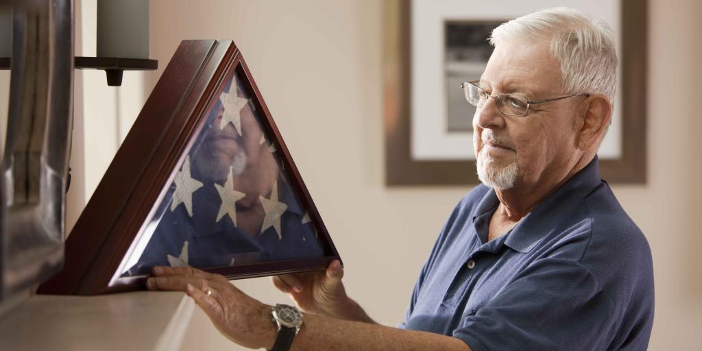 Veteran looking at shadow box