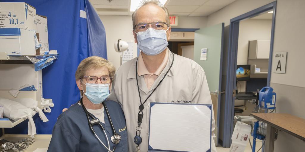 Dr. Paul Nemeth displays his Patriot Award from the Department of Defense alongside his nominator, Kristine Nicoletto. Nemeth is chief of Emergency Medicine at Edward Hines, Jr. VA Hospital. He received the award for his eight years of supervisor support to Nicoletto, a lieutenant colonel in the Illinois Air National Guard's 182nd Medical Group. The award is given to civilian supervisors for directly supporting Military Reserve and National Guard members. (Photo by Jeff Howerton)