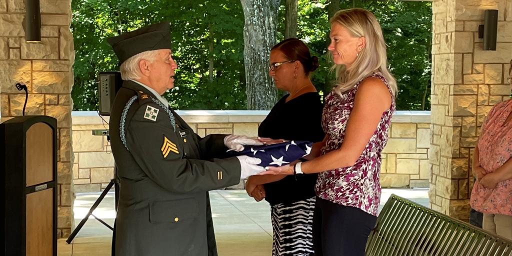 OWR Ladies members, Kat Frey and Becky Clark receiving the U.S. flag on behalf of the families of unattended burials.