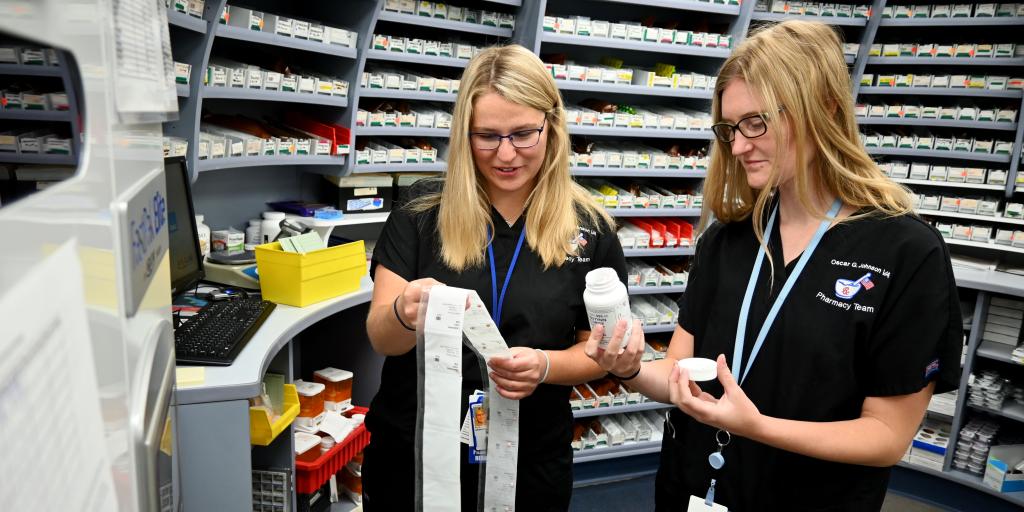 Image of two pharmacists looking at medications