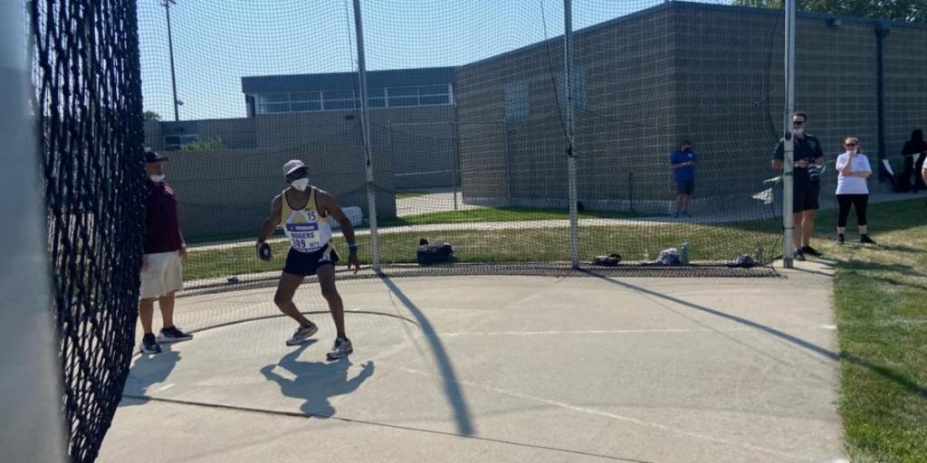 Owen Rogers competing in the discus throw. 