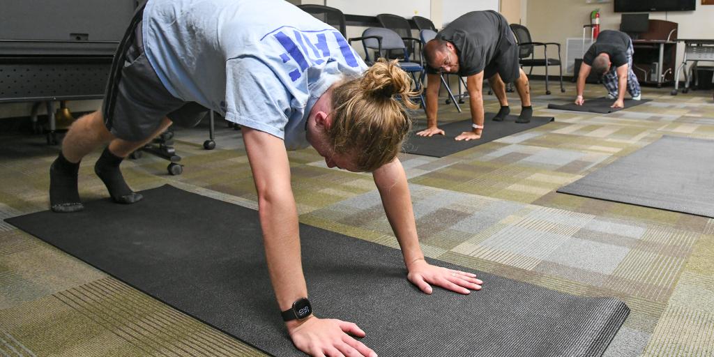 Recreation Therapist Caleb Campbell leads a Yoga class.