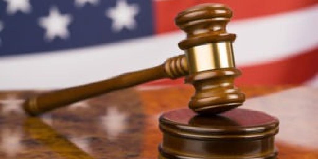 Courtroom gavel in front of American flag