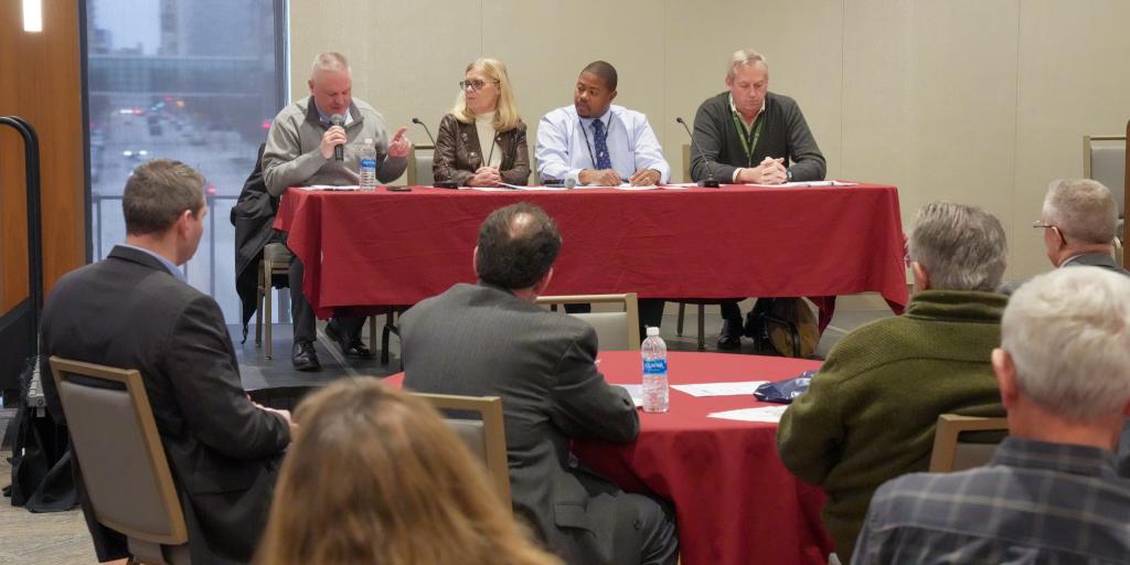 Attendees listen to a panel discussion about the PACT Act.
