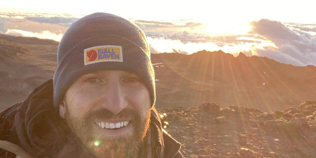Tony Moro selfie of sunrise atop Mount Kilimanjaro