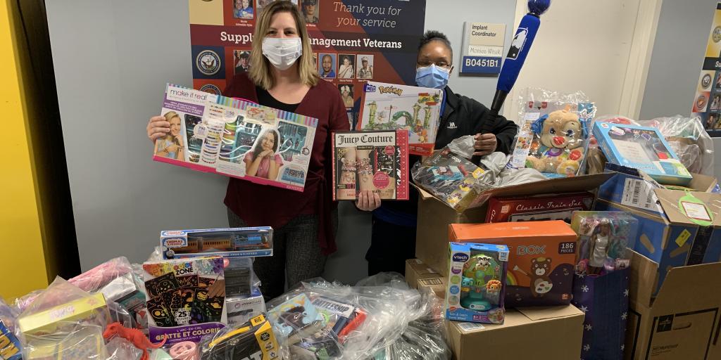 Women display toys bought for toy drive