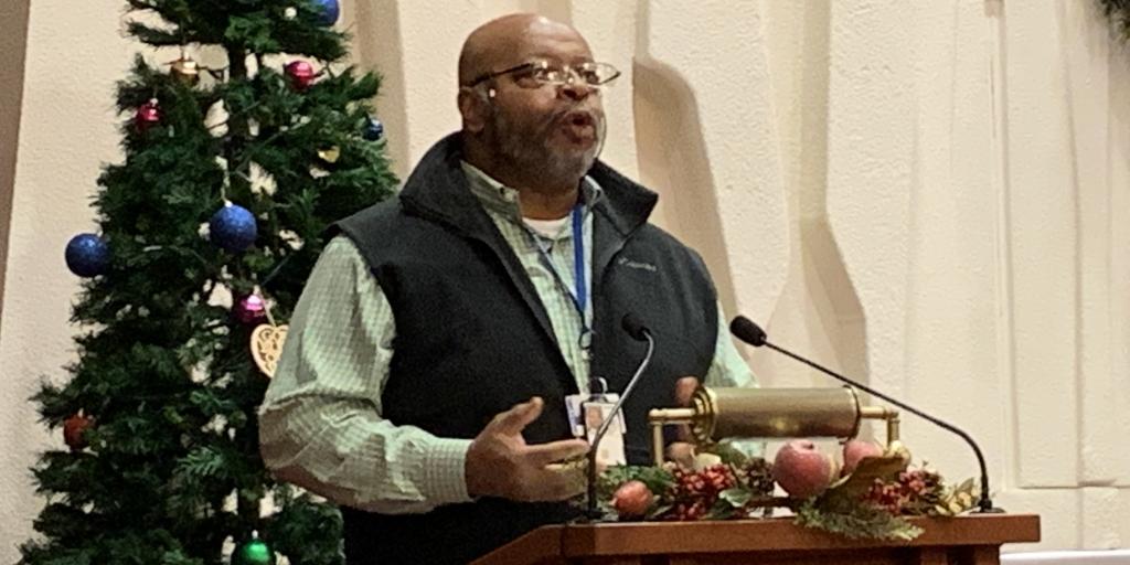 Will Johnson speaking at a lectern