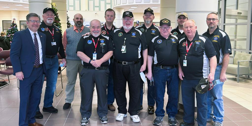 Group of Veteran mentors and judge pose for a photo.
