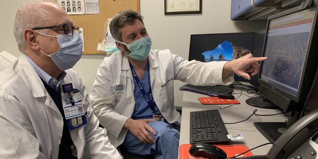 Doctors looking at computer screen