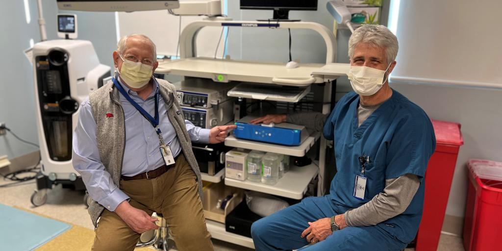 Dr. Thomas Schiller (left) and Dr. Drake Rippelmeyer (right) show off the new artificial intelligence endoscopy device.