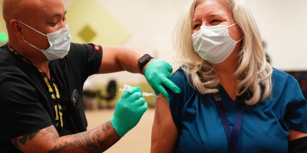 male veteran along with female nurse during vaccination