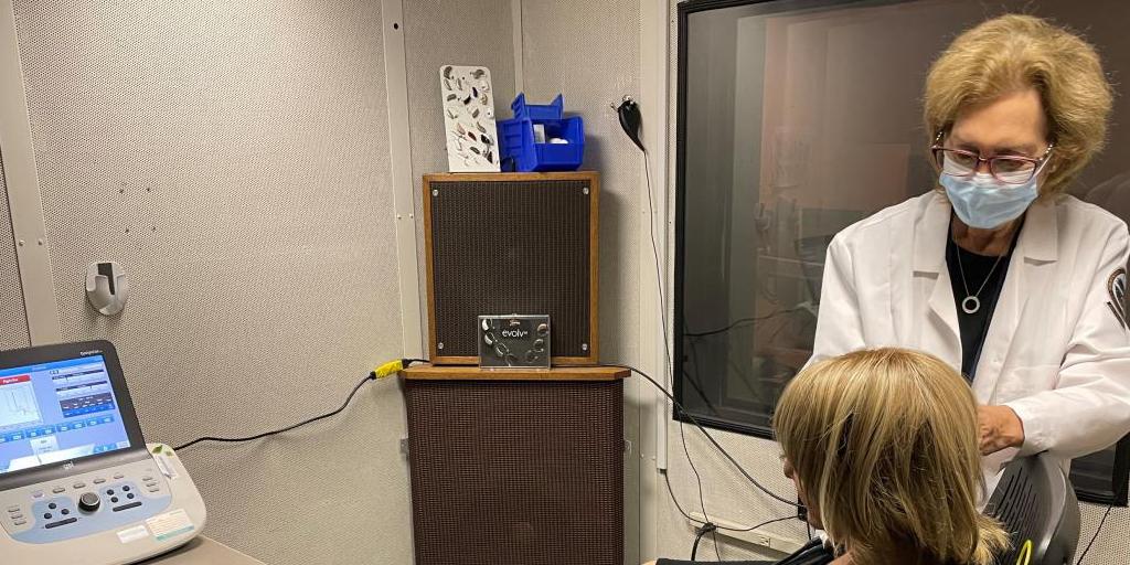 Chief of Audiology and Speech Pathology, Dr. Stephanie Givan examines a patient who suffers constant buzzing in one ear.
