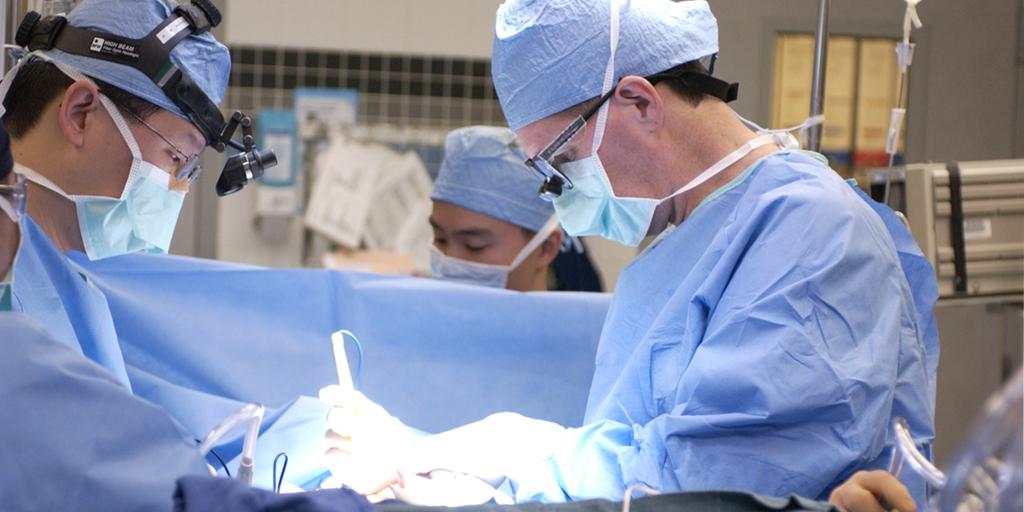 Dr. Cameron on the right operating on a patient