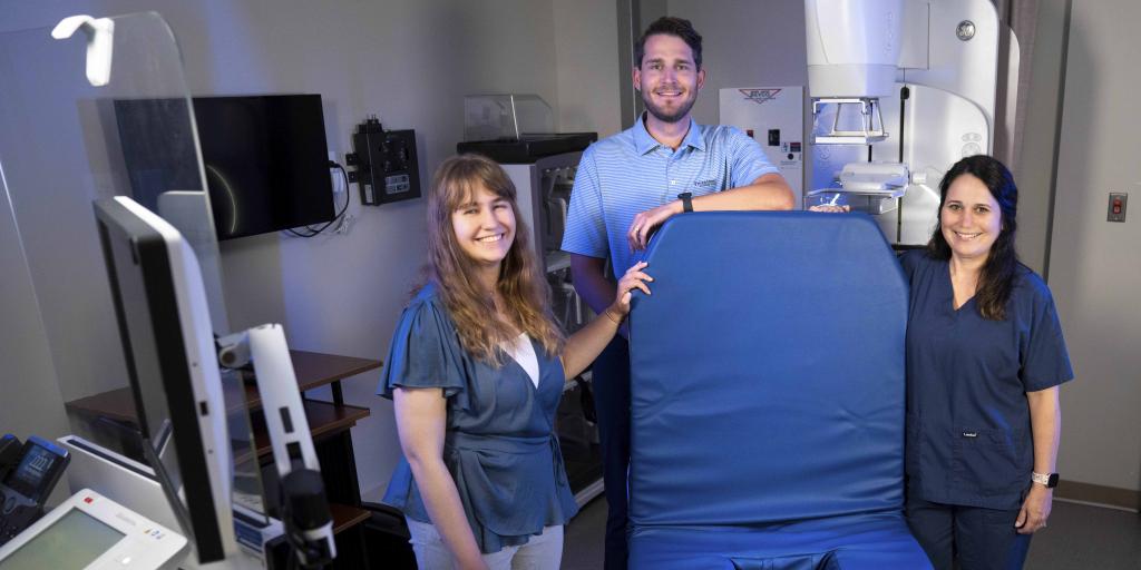 Raychel Testa, Frank Zitko and Natalie Mandel display their modified mammography chair design.