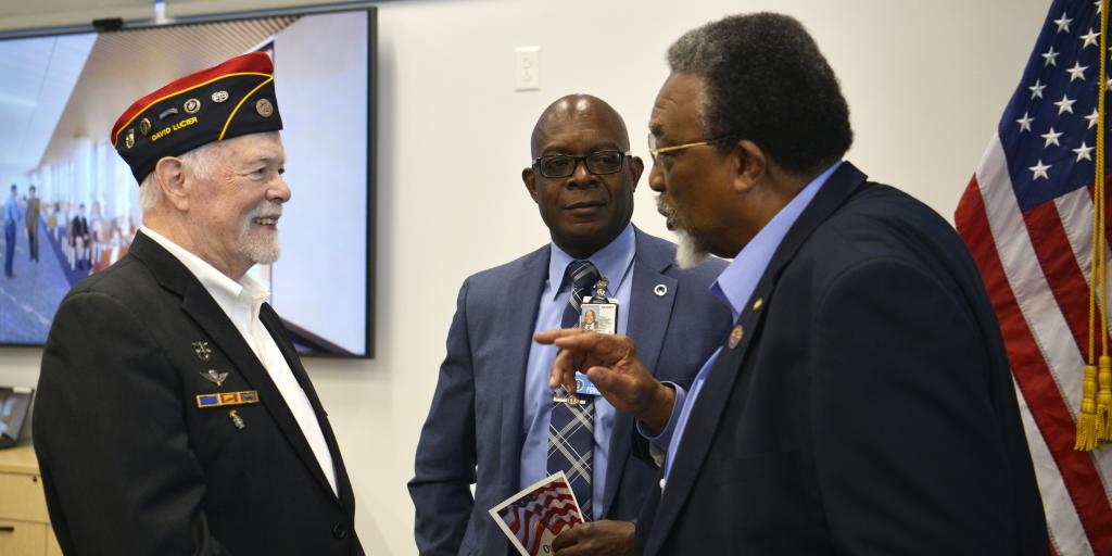Medical Center Director Bryan Matthews speaks with Veterans during ceremony