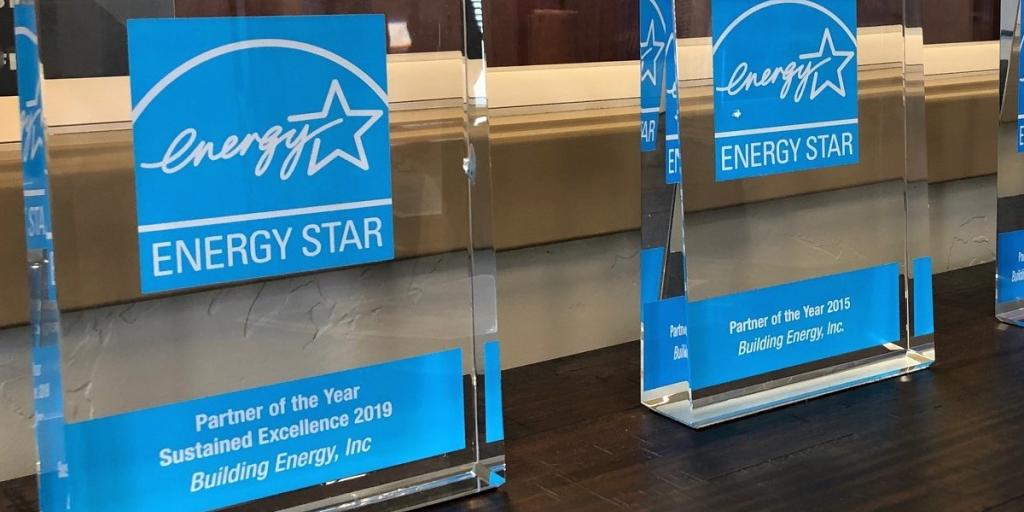 Two transparent glass awards that read Energy Star with light blue background behind the words.