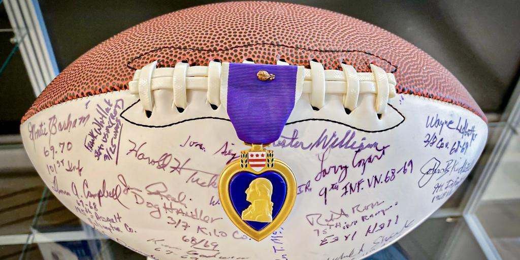 The Purple Heart football on display in its glass case.