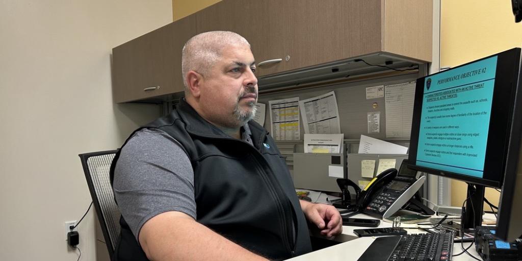 A man sits at his computer and facilitates a virtual active threat training session.
