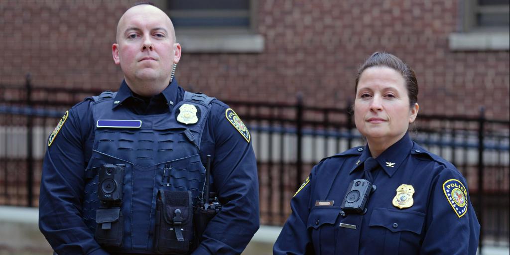 va police officers standing - one male and one female