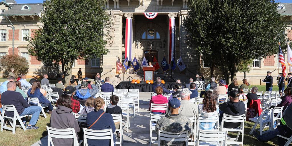 Attendees look on as East Tennessee State University ROTC cadets march on the colors during a ceremony to honor Mountain Home VA's 120th birthday.